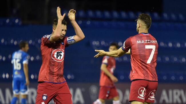 Chile's Huachipato Argentine Walter Mazzantti (R) celebrates with teammate Claudio Sepulveda after scoring against Paraguay's 12 de Octubre during the Copa Sudamericana football tournament group stage match at the Luis Alfonso Giagni stadium in Villa Elisa, Paraguay, on May 12, 2021. (Photo by NORBERTO DUARTE / AFP) (Photo by NORBERTO DUARTE/AFP via Getty Images)