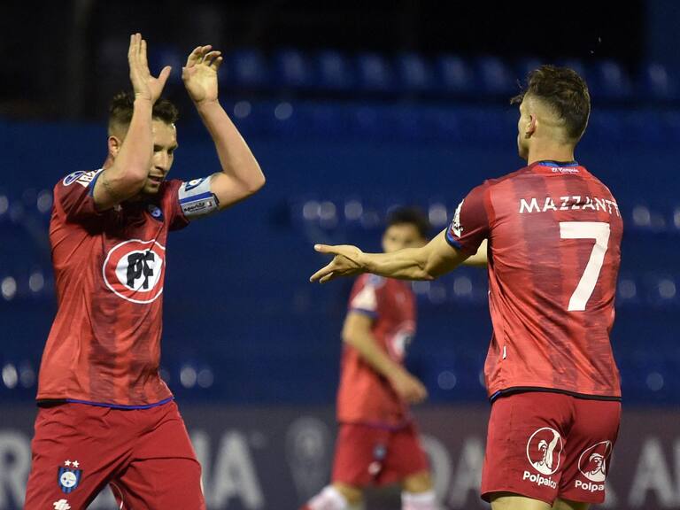 Chile's Huachipato Argentine Walter Mazzantti (R) celebrates with teammate Claudio Sepulveda after scoring against Paraguay's 12 de Octubre during the Copa Sudamericana football tournament group stage match at the Luis Alfonso Giagni stadium in Villa Elisa, Paraguay, on May 12, 2021. (Photo by NORBERTO DUARTE / AFP) (Photo by NORBERTO DUARTE/AFP via Getty Images)