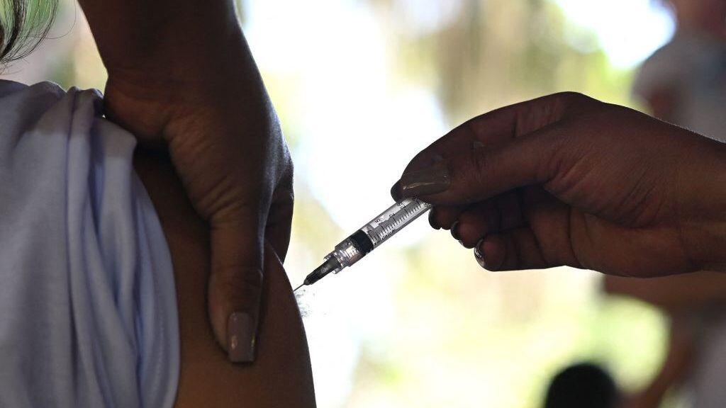 A resident receives a dose of AstraZeneca/Oxford vaccine against Covid-19 during the first day of a mass vaccination campaign within the 'Paqueta Vaccinated' project, at Paqueta island in Rio de Janeiro, Brazil on June 20, 2021. - Rio de Janeiro Municipal Health Department, with the support of the Oswaldo Cruz Foundation (Fiocruz), is carrying out the project in the island to evaluate the effects of immunization on a large scale. (Photo by Andre Borges / AFP) (Photo by ANDRE BORGES/AFP via Getty Images)
