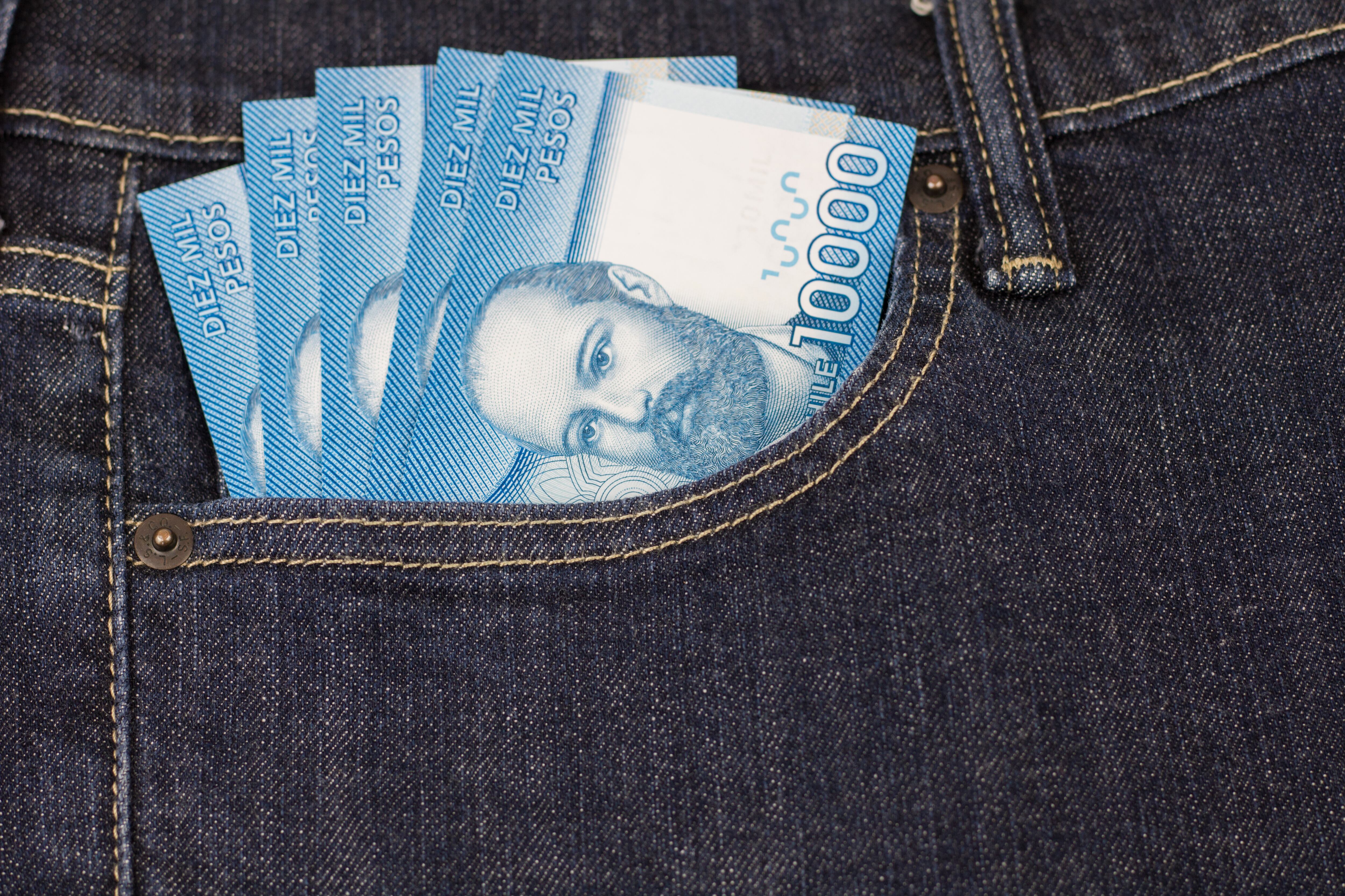 High resolution image. Chilean pesos bills in jeans pocket. Ten thousands.