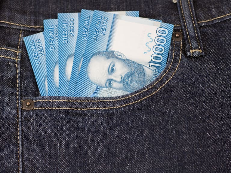 High resolution image. Chilean pesos bills in jeans pocket. Ten thousands.