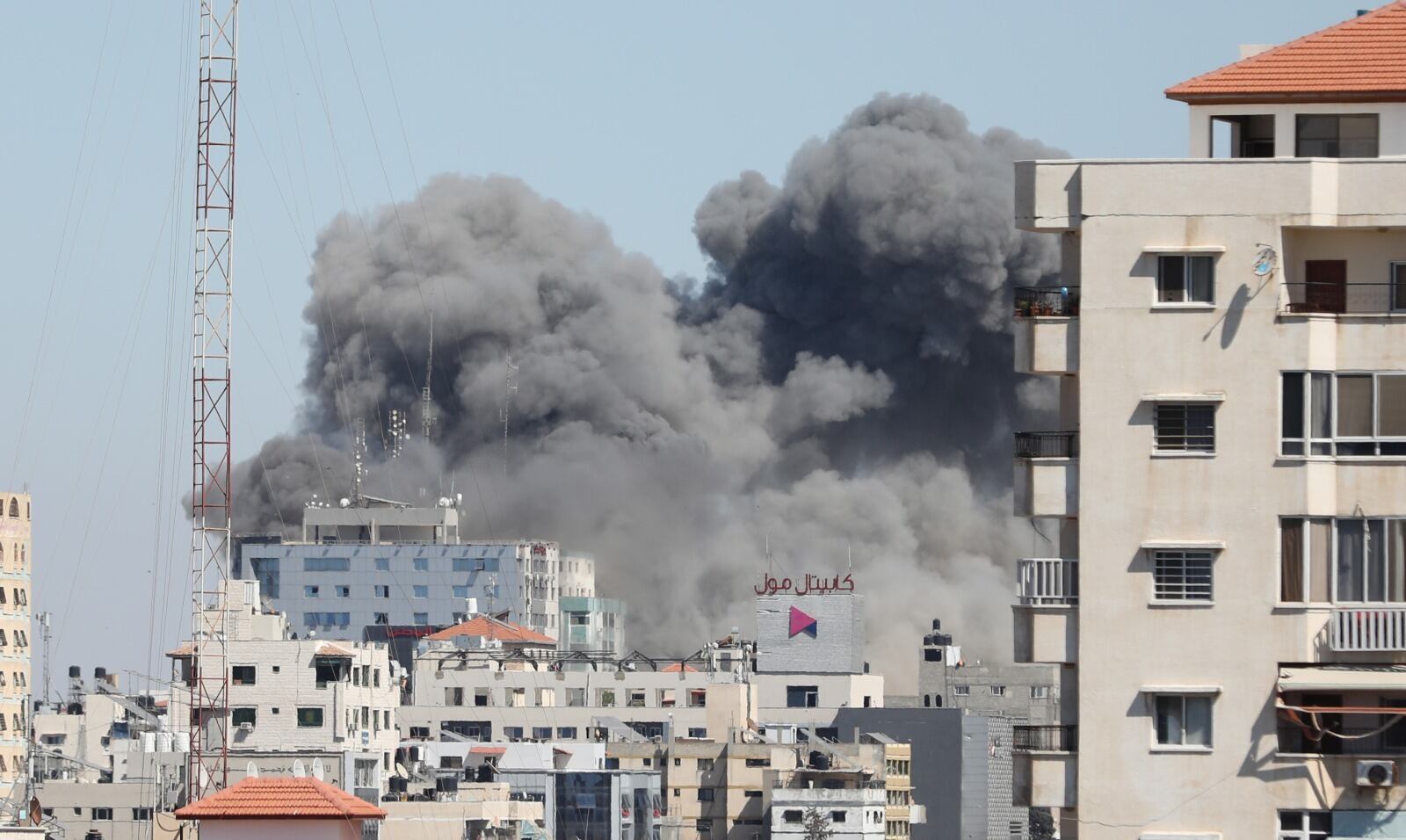 GAZA CITY, GAZA - MAY 15: Smoke rises after sraeli forces destroyed building in Gaza City where Al-Jazeera, Associated Press had their offices, on May 15, 2021. (Photo by Mustafa Hassona/Anadolu Agency via Getty Images)