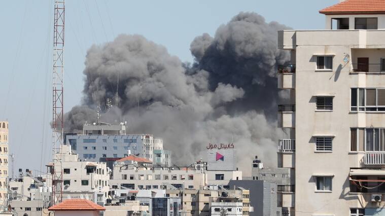 GAZA CITY, GAZA - MAY 15: Smoke rises after sraeli forces destroyed building in Gaza City where Al-Jazeera, Associated Press had their offices, on May 15, 2021. (Photo by Mustafa Hassona/Anadolu Agency via Getty Images)