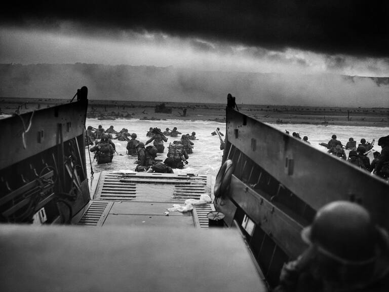 US Troops wading through water after reaching Normandy and landing Omaha beach on D Day, 1944. (Photo by: Universal History Archive/Universal Images Group via Getty Images)