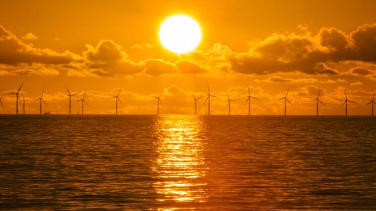 Sunset over the Walney offshore Wind farm from Walney island showing both the wind turbines and a gas platform further out in Morecambe Bay. The windfarm will shortly be the largest offshore wind farm in the world and currently generates 367 MW.