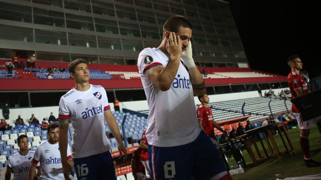 Uruguay's Nacional Gabriel Neves covers his ears as fireworks are launched before the closed-door Copa Libertadores quarterfinal football match against Argentina's River Plate at the Gran Parque Central stadium in Montevideo on December 17, 2020. (Photo by Ernesto RYAN / POOL / AFP) (Photo by ERNESTO RYAN/POOL/AFP via Getty Images)