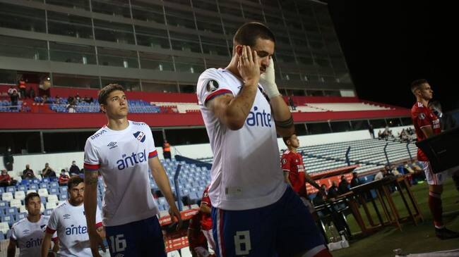 Uruguay's Nacional Gabriel Neves covers his ears as fireworks are launched before the closed-door Copa Libertadores quarterfinal football match against Argentina's River Plate at the Gran Parque Central stadium in Montevideo on December 17, 2020. (Photo by Ernesto RYAN / POOL / AFP) (Photo by ERNESTO RYAN/POOL/AFP via Getty Images)