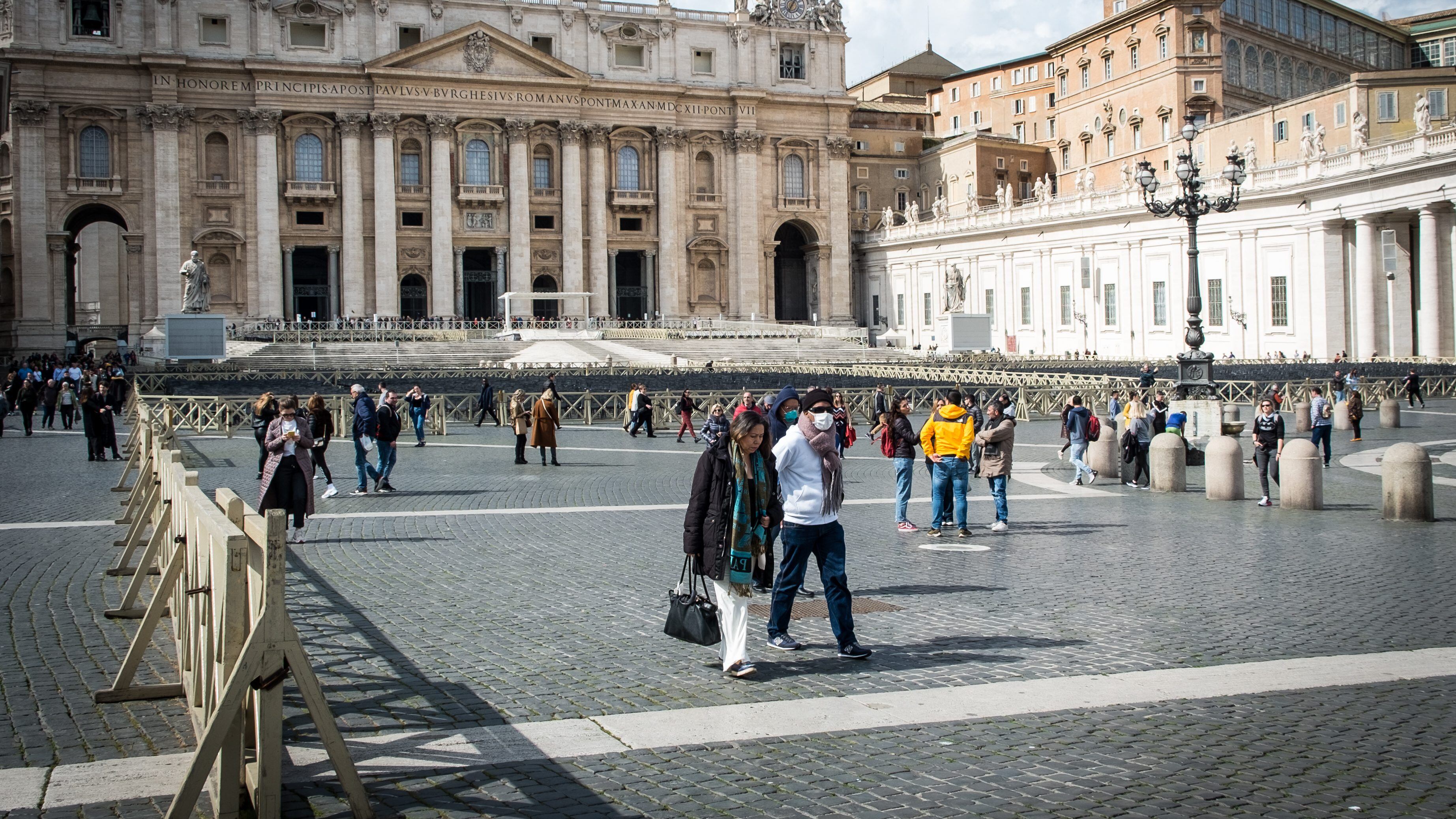 Tourists wear face protective masks in the St. Peter's square on March 7, 2020 in Rome, Italy. The Vatican reported its first coronavirus case, saying it had suspended outpatient services at its health clinic after a patient tested positive for Coronavirus (Covid-19) (Photo by Andrea Ronchini/NurPhoto via Getty Images)