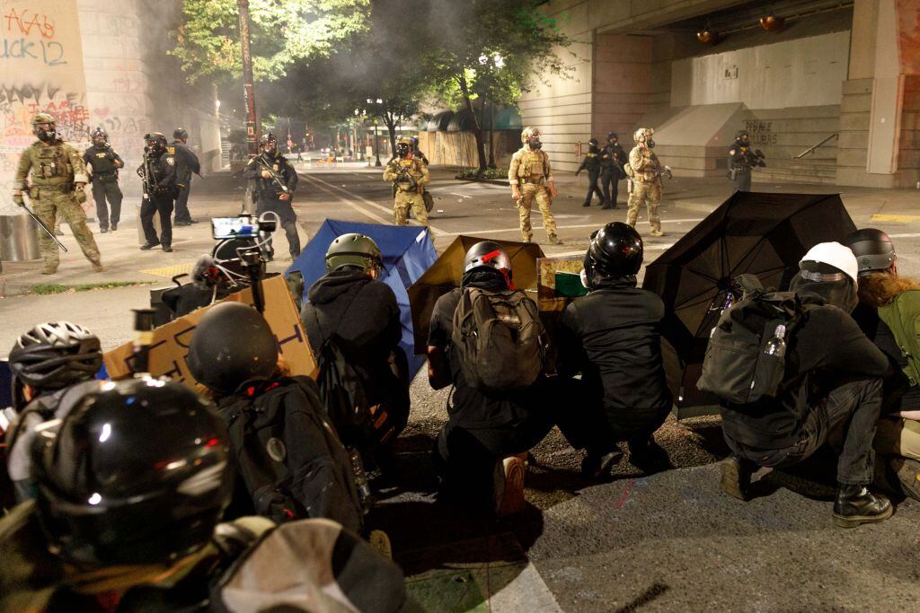 Manifestantes se cubren ante la presencial policial en EEUU