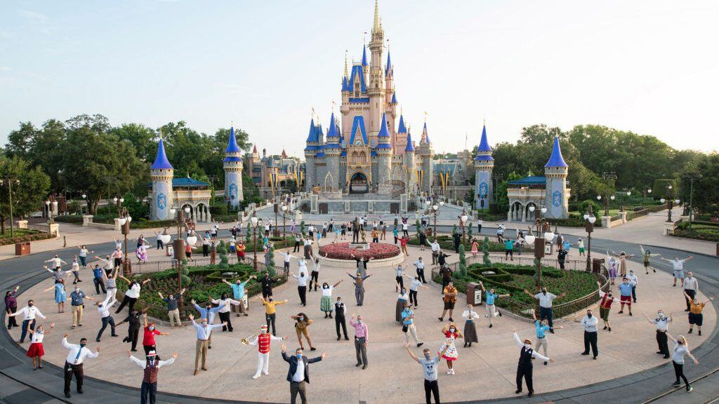 LAKE BUENA VISTA, FL - JULY 11: In this handout photo provided by Walt Disney World Resort, Josh DAmaro, chairman of Disney Parks, Experiences and Products (center front right) and Jeff Vahle, president of Walt Disney World Resort (center front left), pose with Disney cast members for a photo in front of Cinderella Castle prior to the phased reopening of Magic Kingdom Park at Walt Disney World Resort on July 11, 2020 in Lake Buena Vista, Florida. (Photo by David Roark/Walt Disney World Resort via Getty Images)