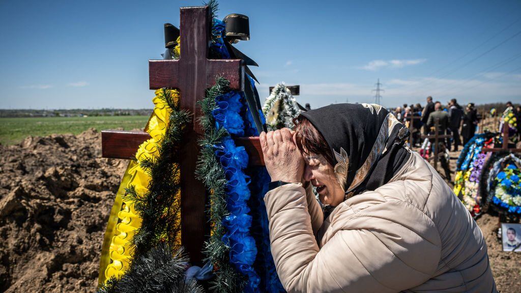 DNIPRO, UKRAINE - 2022/05/07: A mother mourns near her son, Vitaliy's tomb at a cemetery in Dnipro. Following the invasion of Ukraine, marking the biggest military invasion in Europe since WWII, the bloody war has left civilians displaced and numerous civilians and soldiers killed as Russian forces strengthened their attack on the country's east and south amid the Russian May-9 Victory Day. (Photo by Alex Chan Tsz Yuk/SOPA Images/LightRocket via Getty Images)