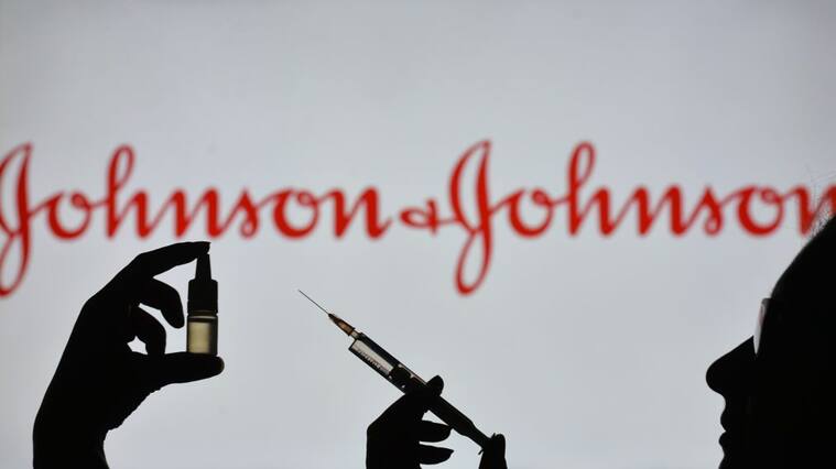 IRELAND - 2021/02/07: In this photo illustration a silhouette of a man holding a medical syringe and a vial seen displayed in front of the Johnson and Johnson logo on a screen. (Photo Illustration by Cezary Kowalski/SOPA Images/LightRocket via Getty Images)