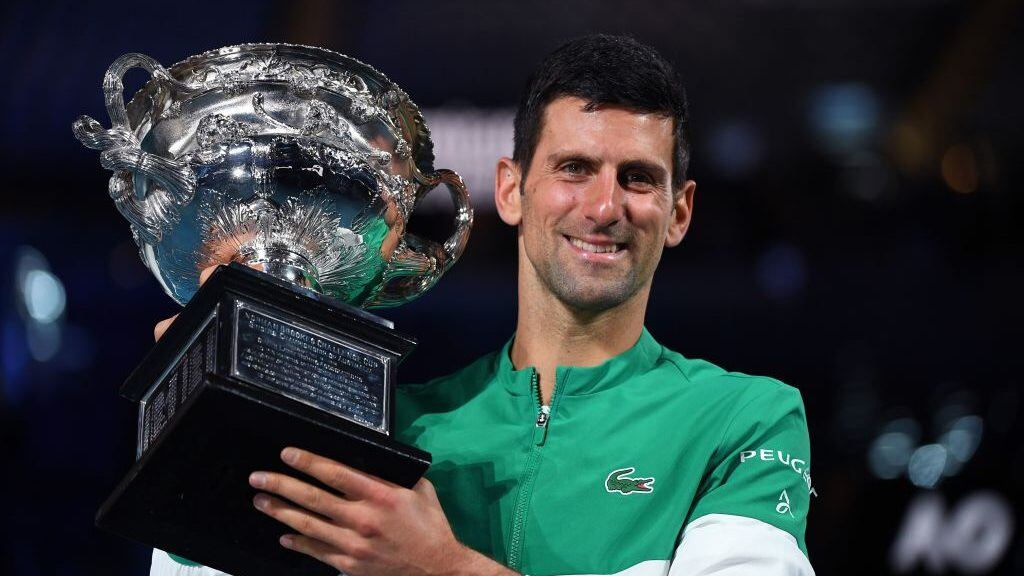 Serbia's Novak Djokovic poses with the Norman Brookes Challenge Cup trophy following his victory against Russia's Daniil Medvedev in their men's singles final match on day fourteen of the Australian Open tennis tournament in Melbourne on February 21, 2021. (Photo by William WEST / AFP) / -- IMAGE RESTRICTED TO EDITORIAL USE - STRICTLY NO COMMERCIAL USE -- (Photo by WILLIAM WEST/AFP via Getty Images)