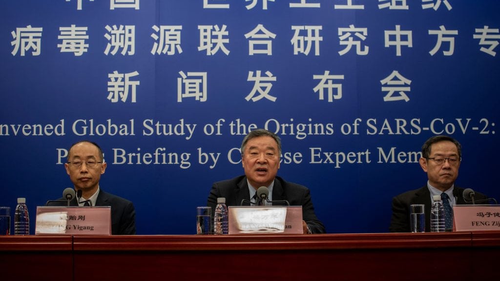 BEIJING, CHINA - MARCH 31: Head of the Expert Group on Covid Response at China's National Health Commission Liang Wannian, center, answers a question as Tong Yigang, left, and Feng Zijian, right, listen during a press conference addressing the World Health Organization (WHO) report on the origins of SARS-CoV-2, at the National Health Committee on March 31, 2021 in Beijing, China. (Photo by Kevin Frayer/Getty Images)