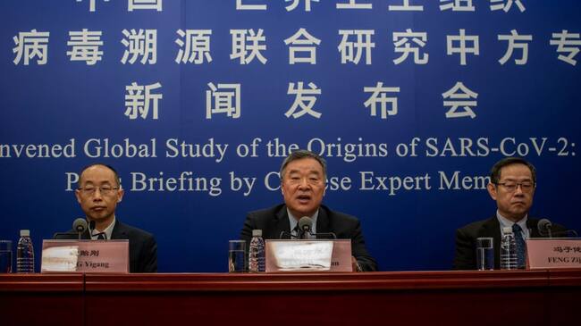 BEIJING, CHINA - MARCH 31: Head of the Expert Group on Covid Response at China's National Health Commission Liang Wannian, center, answers a question as Tong Yigang, left, and Feng Zijian, right, listen during a press conference addressing the World Health Organization (WHO) report on the origins of SARS-CoV-2, at the National Health Committee on March 31, 2021 in Beijing, China. (Photo by Kevin Frayer/Getty Images)