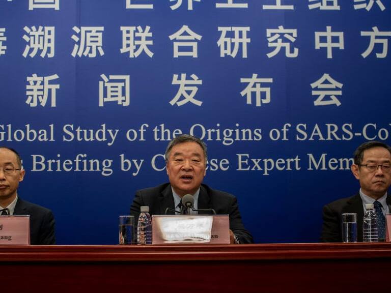 BEIJING, CHINA - MARCH 31: Head of the Expert Group on Covid Response at China&#039;s National Health Commission Liang Wannian, center, answers a question as Tong Yigang, left, and Feng Zijian, right, listen during a press conference addressing the World Health Organization (WHO) report on the origins of SARS-CoV-2, at the National Health Committee on March 31, 2021 in Beijing, China. (Photo by Kevin Frayer/Getty Images)