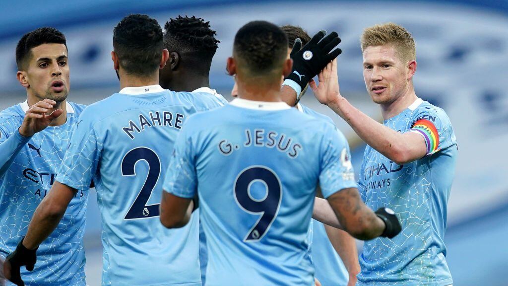 MANCHESTER, ENGLAND - DECEMBER 05: Kevin De Bruyne of Manchester City celebrates with teammate Riyad Mahrez and Gabriel Jesus after scoring his team's second goal during the Premier League match between Manchester City and Fulham at Etihad Stadium on December 05, 2020 in Manchester, England. The match will be played without fans, behind closed doors as a Covid-19 precaution. (Photo by Dave Thompson - Pool/Getty Images)