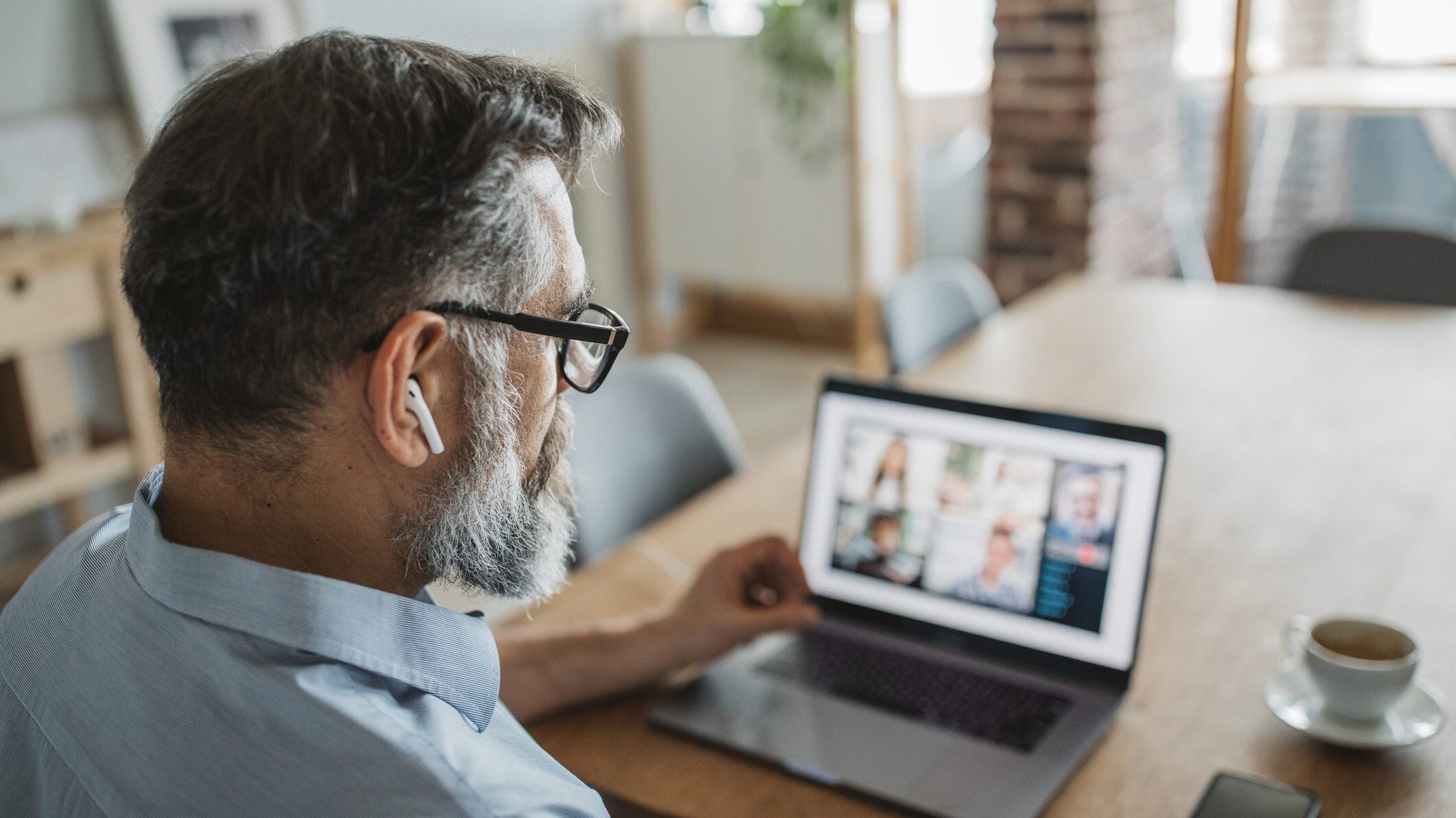 Mature men at home during pandemic isolation have conference  call