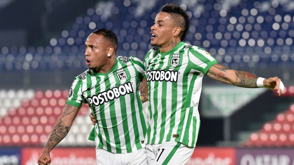 Colombia's Atletico Nacional Jarlan Barrera (L) celebrates with Uruguayan teammate Jonatan Alvez after scoring a goal deflected into the net by Paraguay's Guarani Alexis Villalba during their Copa Libertadores football tournament second round match at Defensores del Chaco Stadium in Asuncion on March 11, 2021. (Photo by Norberto DUARTE / AFP) (Photo by NORBERTO DUARTE/AFP via Getty Images)