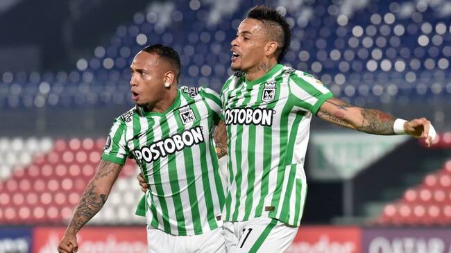 Colombia's Atletico Nacional Jarlan Barrera (L) celebrates with Uruguayan teammate Jonatan Alvez after scoring a goal deflected into the net by Paraguay's Guarani Alexis Villalba during their Copa Libertadores football tournament second round match at Defensores del Chaco Stadium in Asuncion on March 11, 2021. (Photo by Norberto DUARTE / AFP) (Photo by NORBERTO DUARTE/AFP via Getty Images)