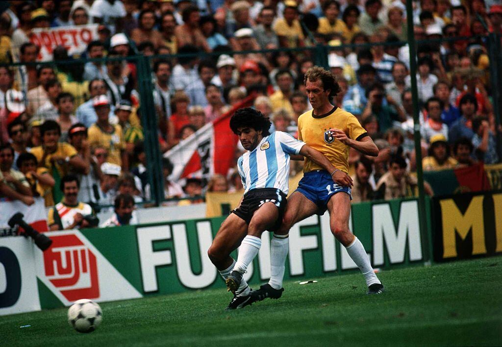 1982 World Cup Second Round Group C match between Brazil and Argentina at the Sarria Stadium, Barcelona on 2nd July 1982, won 3-1 by Brazil, Diego Maradona holds off a challenge from Falcao. (Photo by John Varley/Mirror Syndication International/Mirrorpix via Getty Images)