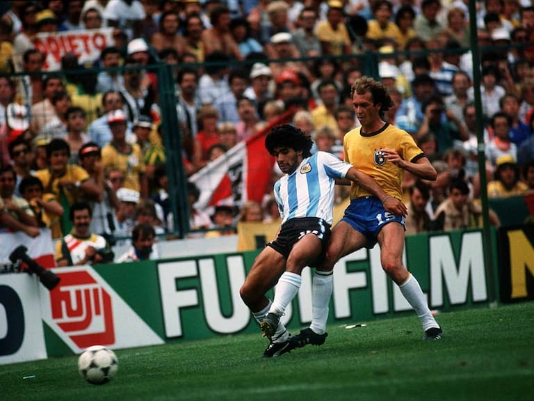 1982 World Cup Second Round Group C match between Brazil and Argentina at the Sarria Stadium, Barcelona on 2nd July 1982, won 3-1 by Brazil, Diego Maradona holds off a challenge from Falcao. (Photo by John Varley/Mirror Syndication International/Mirrorpix via Getty Images)