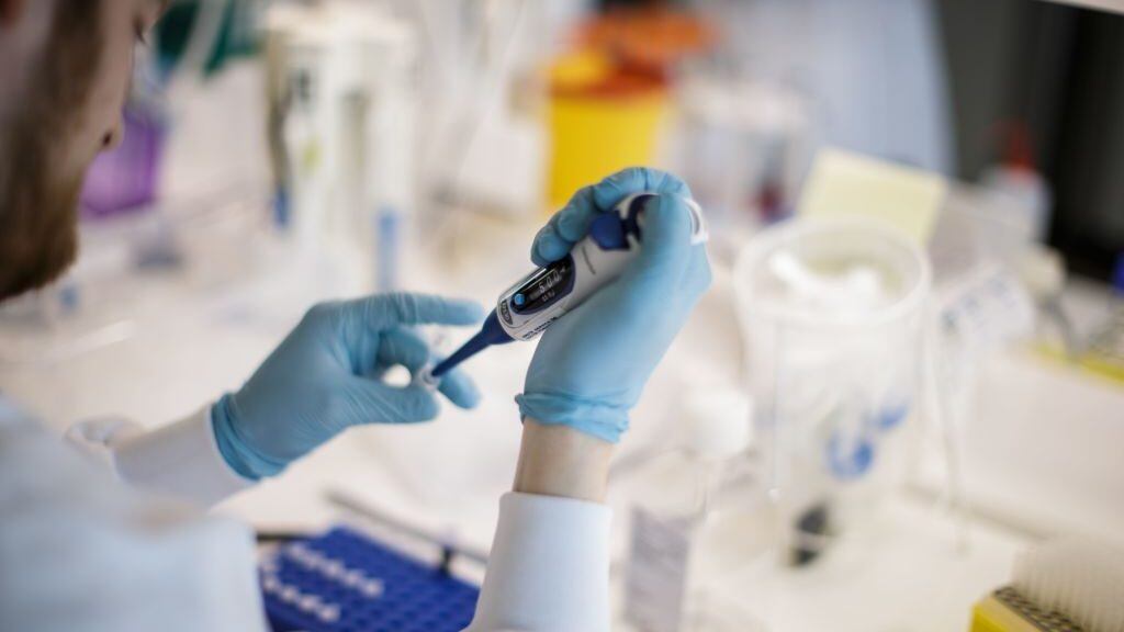TOPSHOT - A researcher works on a vaccine against the new coronavirus COVID-19 at the Copenhagen's University research lab in Copenhagen, Denmark, on March 23, 2020. - At Copenhagen university, a team of about 10 researchers is working around the clock to develop a vaccine against Covid-19 that could apply for clinical trial before within nine months. The vaccine will be based on two components : the protein which is on the surface of the coronavirus, called the spike protein that researchers express in the lab and then attach it on the surface of a virus-like particle. (Photo by Thibault Savary / AFP) (Photo by THIBAULT SAVARY/AFP via Getty Images)