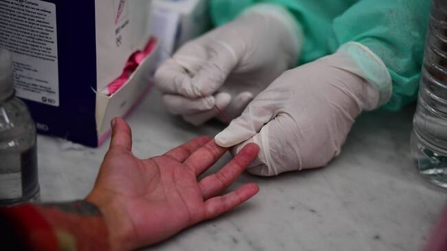 Argentinian Health Ministry staff make blood tests to track the new coronavirus at Constitution train station, in Buenos Aires, on April 24, 2020. (Photo by RONALDO SCHEMIDT / AFP) (Photo by RONALDO SCHEMIDT/AFP via Getty Images)