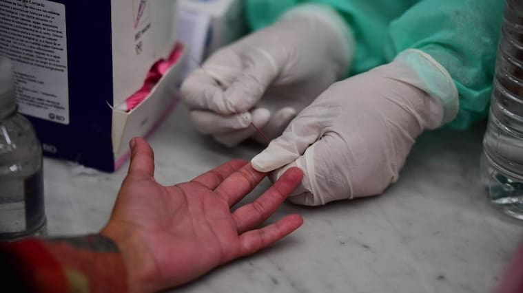 Argentinian Health Ministry staff make blood tests to track the new coronavirus at Constitution train station, in Buenos Aires, on April 24, 2020. (Photo by RONALDO SCHEMIDT / AFP) (Photo by RONALDO SCHEMIDT/AFP via Getty Images)