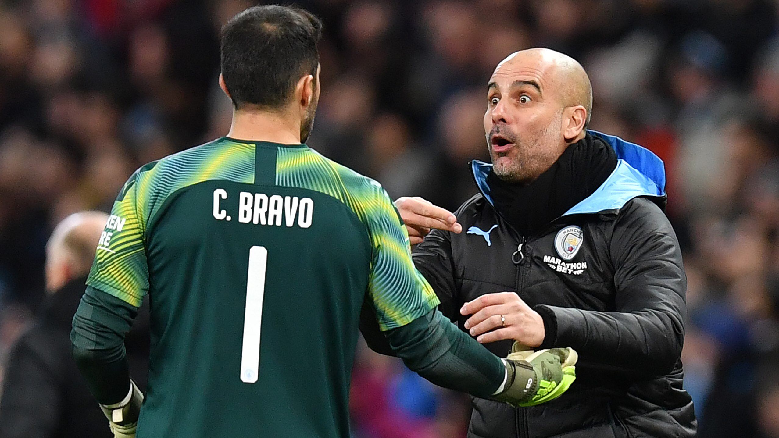 Manchester City's Spanish manager Pep Guardiola (R) gives instructions to Manchester City's Chilean goalkeeper Claudio Bravo during the English League Cup semi-final second leg football match between Manchester City and Manchester United at the Etihad Stadium in Manchester, north west England, on January 29, 2020. (Photo by Paul ELLIS / AFP) / RESTRICTED TO EDITORIAL USE. No use with unauthorized audio, video, data, fixture lists, club/league logos or 'live' services. Online in-match use limited to 120 images. An additional 40 images may be used in extra time. No video emulation. Social media in-match use limited to 120 images. An additional 40 images may be used in extra time. No use in betting publications, games or single club/league/player publications. / (Photo by PAUL ELLIS/AFP via Getty Images)