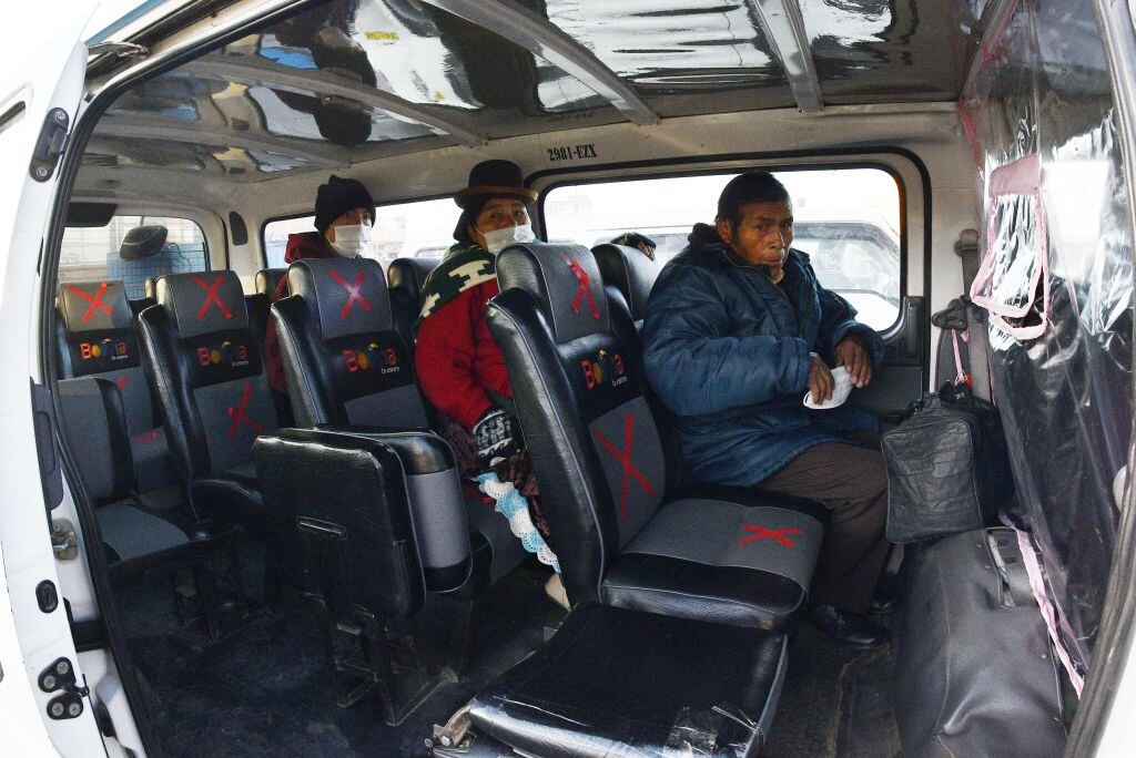 People wear face masks and keep social distance as they use the public transport after the government relaxed the strict quarantine of more than two months due to the new coronavirus, COVID-19, in El Alto, Bolivia on June 1, 2020. (Photo by AIZAR RALDES / AFP) (Photo by AIZAR RALDES/AFP via Getty Images)