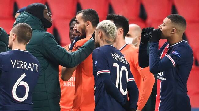 Istanbul Basaksehir's French forward Demba Ba (L) gestures past Paris Saint-Germain's French forward Kylian Mbappe (R) and Paris Saint-Germain's Brazilian forward Neymar (C) after the game was suspended amid allegations of racism by one of the match officials during the UEFA Champions League group H football match between Paris Saint-Germain (PSG) and Istanbul Basaksehir FK at the Parc des Princes stadium in Paris, on December 8, 2020. - Paris Saint-Germain's decisive Champions League game with Istanbul Basaksehir was suspended today in the first half as the players walked off amid allegations of racism by one of the match officials.The row erupted after Basaksehir assistant coach Pierre Webo, the former Cameroon international, was shown a red card during a fierce row on the touchline with staff from the Turkish club appearing to accuse the Romanian fourth official of using a racist term. (Photo by FRANCK FIFE / AFP) (Photo by FRANCK FIFE/AFP via Getty Images)