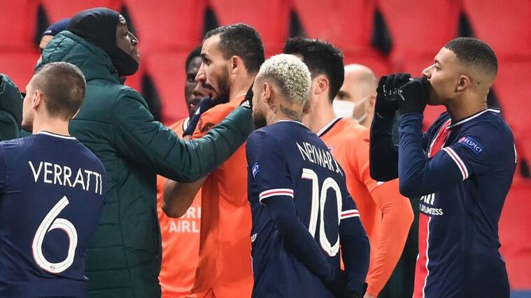Istanbul Basaksehir's French forward Demba Ba (L) gestures past Paris Saint-Germain's French forward Kylian Mbappe (R) and Paris Saint-Germain's Brazilian forward Neymar (C) after the game was suspended amid allegations of racism by one of the match officials during the UEFA Champions League group H football match between Paris Saint-Germain (PSG) and Istanbul Basaksehir FK at the Parc des Princes stadium in Paris, on December 8, 2020. - Paris Saint-Germain's decisive Champions League game with Istanbul Basaksehir was suspended today in the first half as the players walked off amid allegations of racism by one of the match officials.The row erupted after Basaksehir assistant coach Pierre Webo, the former Cameroon international, was shown a red card during a fierce row on the touchline with staff from the Turkish club appearing to accuse the Romanian fourth official of using a racist term. (Photo by FRANCK FIFE / AFP) (Photo by FRANCK FIFE/AFP via Getty Images)