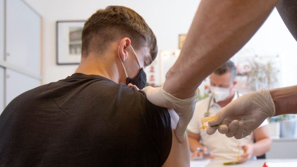 A student is vaccinated against the coronavirus (Covid-19) at a vocational school in Vienna on September 14, 2021. - As of September 14, 2021, mobile vaccination teams in Vienna have been vaccinating against the coronavirus (Covid-19) at some schools. (Photo by ALEX HALADA / AFP) (Photo by ALEX HALADA/AFP via Getty Images)