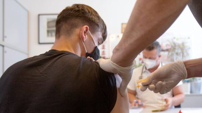 A student is vaccinated against the coronavirus (Covid-19) at a vocational school in Vienna on September 14, 2021. - As of September 14, 2021, mobile vaccination teams in Vienna have been vaccinating against the coronavirus (Covid-19) at some schools. (Photo by ALEX HALADA / AFP) (Photo by ALEX HALADA/AFP via Getty Images)