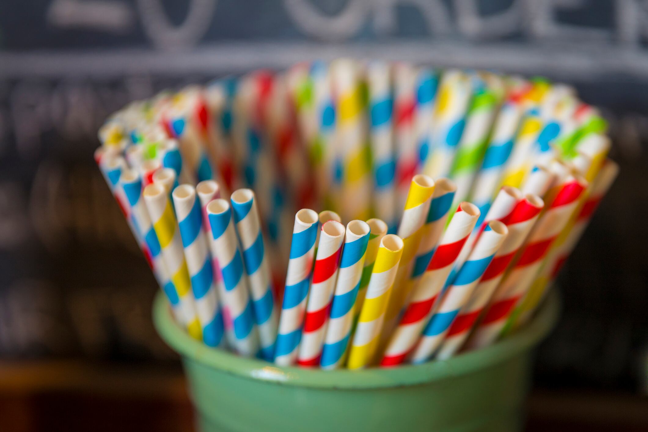 Colorful paper straws at a restaurant being offered instead of plastic ones.