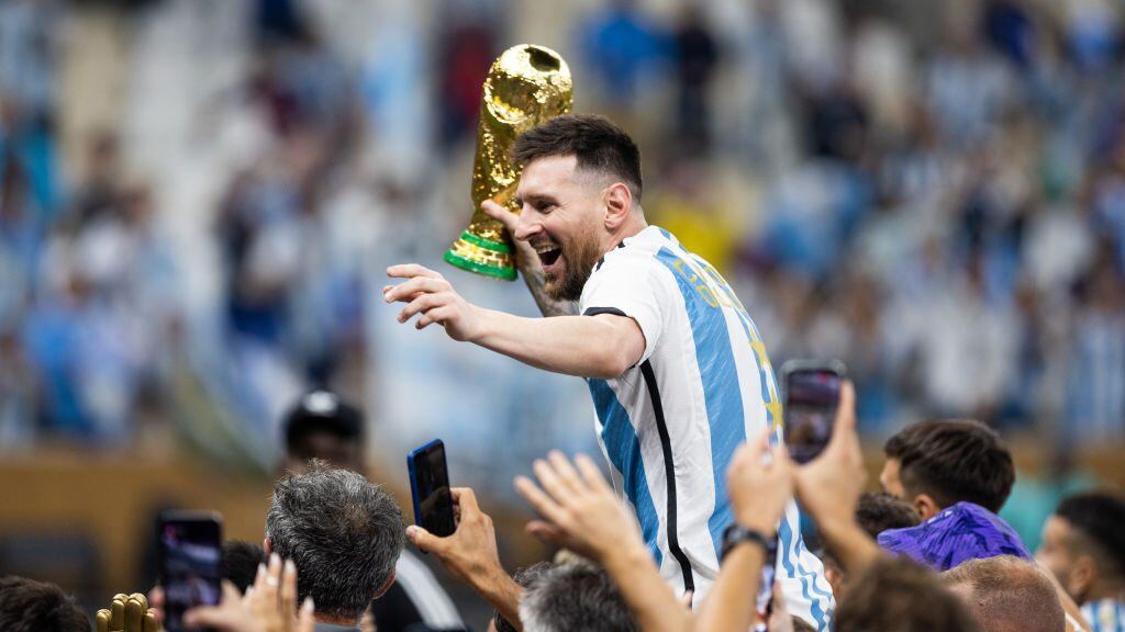 LUSAIL CITY, QATAR - DECEMBER 18: Lionel Messi of Argentina celebrates with the World Cup Trophy after the FIFA World Cup Qatar 2022 Final match between Argentina (3) and France (3) (Argentina win 4-2 on penalties) at Lusail Stadium on December 18, 2022 in Lusail City, Qatar. (Photo by Simon Bruty/Anychance/Getty Images)