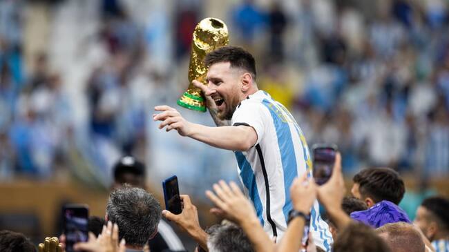LUSAIL CITY, QATAR - DECEMBER 18: Lionel Messi of Argentina celebrates with the World Cup Trophy after the FIFA World Cup Qatar 2022 Final match between Argentina (3) and France (3) (Argentina win 4-2 on penalties) at Lusail Stadium on December 18, 2022 in Lusail City, Qatar. (Photo by Simon Bruty/Anychance/Getty Images)