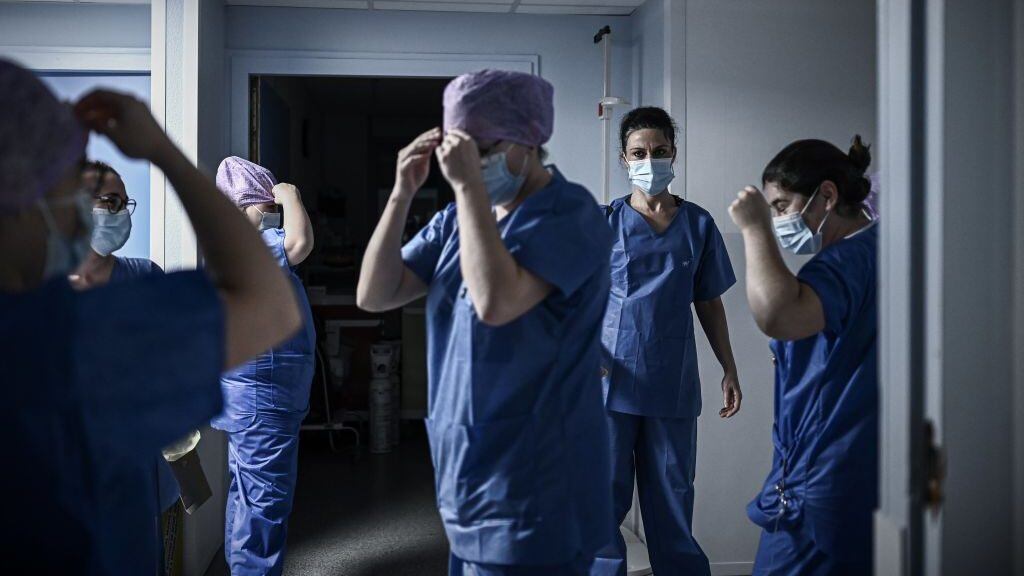 In this picture taken on December 3, 2020, medical health workers get ready for their night shift at the Covid-19 care unit of the Polyclinique Jean Villar private hospital part of the Elsan group, in Bruges, southeastern France. - Vaccination against Covid-19 will be free for all, French Prime Minister Jean Castex announced on December 3, 2020, adding that the government has budgeted for this purpose 1,5 billion euros in the social security budget for 2021. (Photo by Philippe LOPEZ / AFP) (Photo by PHILIPPE LOPEZ/AFP via Getty Images)