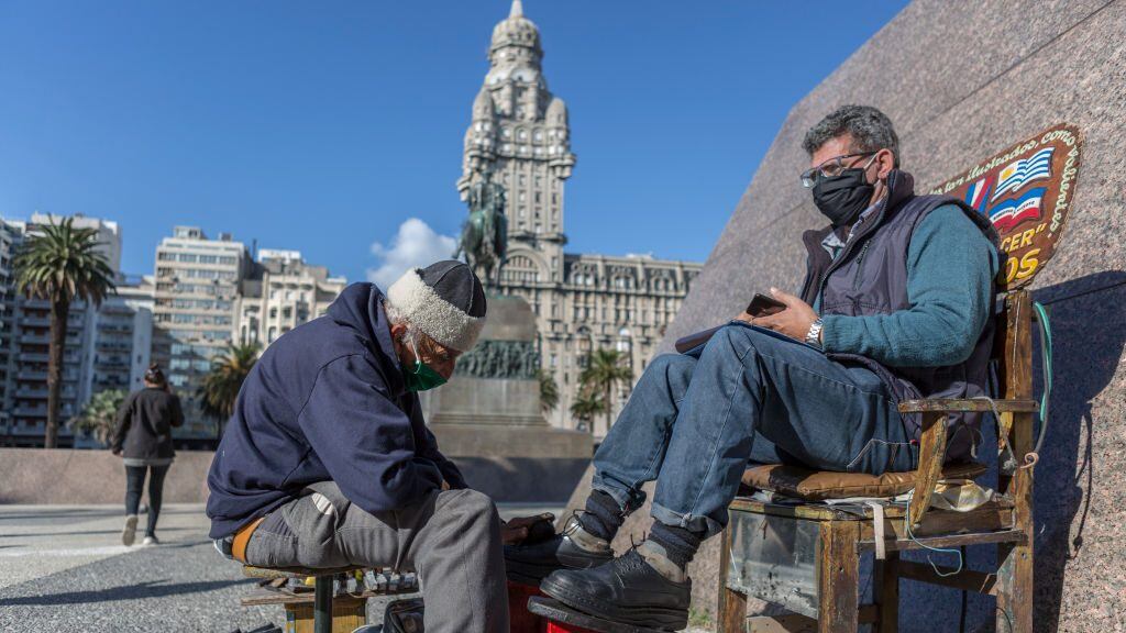 MONTEVIDEO, URUGUAY - MAY 07: A customer gets his shoes polished at Plaza Independencia on May 07, 2020 in Montevideo, Uruguay. President Lacalle Pou called for a reopening of certain industries and encouraged people to take preventive measures against COVID-19 to get back to normal. (Photo by Ernesto Ryan/Getty Images)