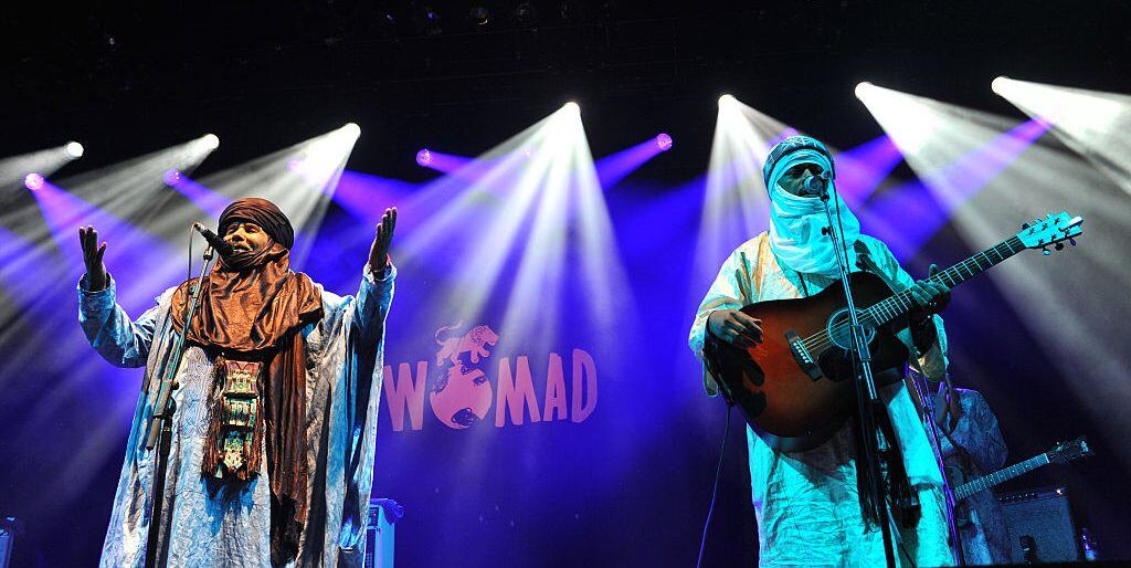 WILTSHIRE, ENGLAND - JULY 24: Tinariwen perform on stage during Day 1 of the Womad Festival at Charlton Park on July 24, 2015 in Wiltshire, England. (Photo by C Brandon/Redferns via Getty Images)