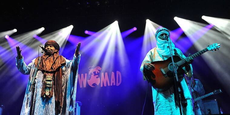 WILTSHIRE, ENGLAND - JULY 24: Tinariwen perform on stage during Day 1 of the Womad Festival at Charlton Park on July 24, 2015 in Wiltshire, England. (Photo by C Brandon/Redferns via Getty Images)