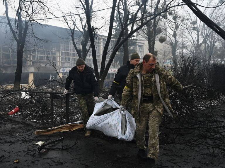 EDITORS NOTE: Graphic content / Police officers remove the body of a passerby killed in yesterday's airstrike that hit Kyiv's main television tower in Kyiv on March 2, 2022. - An apparent Russian airstrike hit Kyiv's main television tower in the heart of the Ukrainian capital on March 1, 2022. (Photo by ARIS MESSINIS / AFP) (Photo by ARIS MESSINIS/AFP via Getty Images)