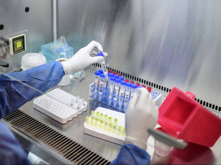 A health worker handles a COVID-19 test at the El Cruce - Dr Nestor Kirchner hospital in Florencio Varela, Argentina on April 13, 2021. - Latin America suffers a new upsurge of the covid-19 pandemic with records in contagions in Argentina and Uruguay, as worldwide immunisation campaigns will be affected in the United States and South Africa by the suspension of the Johnson & Johnson vaccine, which will also delay itrs distribution in Europe. (Photo by RONALDO SCHEMIDT / AFP) (Photo by RONALDO SCHEMIDT/AFP via Getty Images)