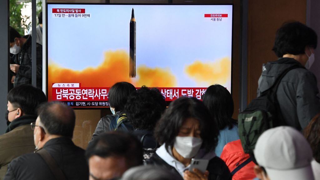 People watch a television screen showing a news broadcast with file footage of a North Korean missile test, at a railway station in Seoul on April 13, 2023. - North Korea fired a ballistic missile on April 13, Seoul's military said, prompting Japan to briefly issue a seek shelter warning to residents of the northern Hokkaido region. (Photo by Jung Yeon-je / AFP) (Photo by JUNG YEON-JE/AFP via Getty Images)
