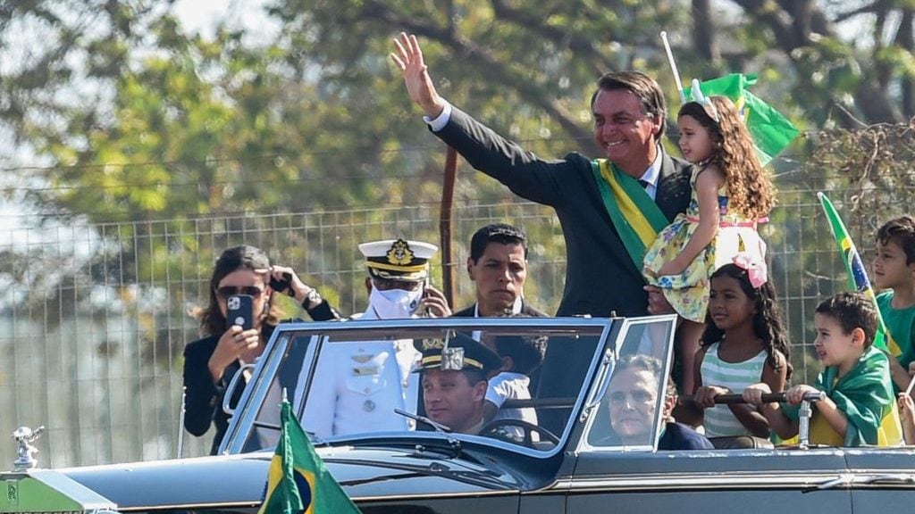 Brazilian President Jair Bolsonaro waves to supporters in his arrival to the flag-raising ceremony at Alvorada Palace, during the Independence Day celebrations in Brasilia, on September 7, 2021. - Fighting record-low poll numbers, a weakening economy and a judiciary he says is stacked against him, President Jair Bolsonaro has called huge rallies for Brazilian independence day Tuesday, seeking to fire up his far-right base. (Photo by EVARISTO SA / AFP) (Photo by EVARISTO SA/AFP via Getty Images)