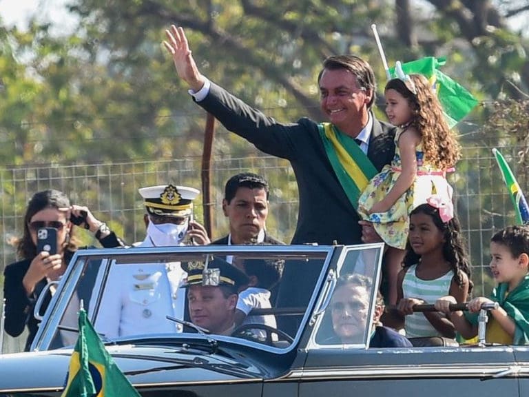 Brazilian President Jair Bolsonaro waves to supporters in his arrival to the flag-raising ceremony at Alvorada Palace, during the Independence Day celebrations in Brasilia, on September 7, 2021. - Fighting record-low poll numbers, a weakening economy and a judiciary he says is stacked against him, President Jair Bolsonaro has called huge rallies for Brazilian independence day Tuesday, seeking to fire up his far-right base. (Photo by EVARISTO SA / AFP) (Photo by EVARISTO SA/AFP via Getty Images)