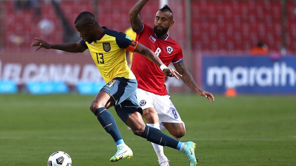QUITO, ECUADOR - SEPTEMBER 05: Enner Valencia of Ecuador competes for the ball with Arturo Vidal of Chile during a match between Ecuador and Chile as part of South American Qualifiers for Qatar 2022 at Rodrigo Paz Delgado Stadium on September 05, 2021 in Quito, Ecuador. (Photo by José Jacomé - Pool/Getty Images)