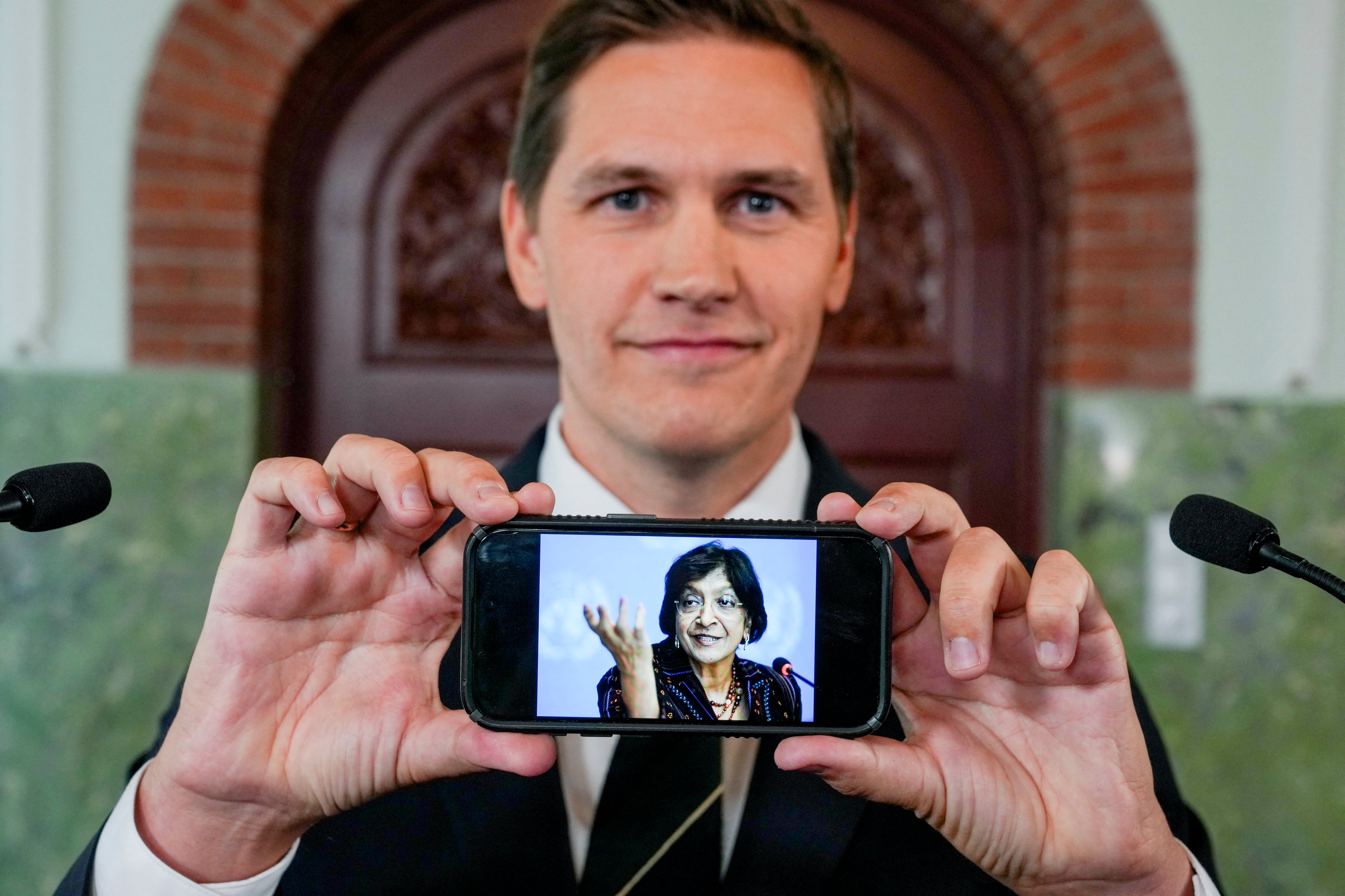 The Chairman of the Nobel Committee, Jørgen Watne Frydnes, shows a mobile phone dispplaying a picture of Navanethem "Navi" Pillay who was awarded the 2026 Nobel Peace Prize at the Nobel Institute in Oslo, Norway, on October 9, 2026. The Norwegian Nobel Committee said Friday it had decided to honour South African human rights champion Navi Pillay at a time when internationl law and institutions were under attack. (Photo by Javad Parsa / NTB / AFP via Getty Images) / Norway OUT