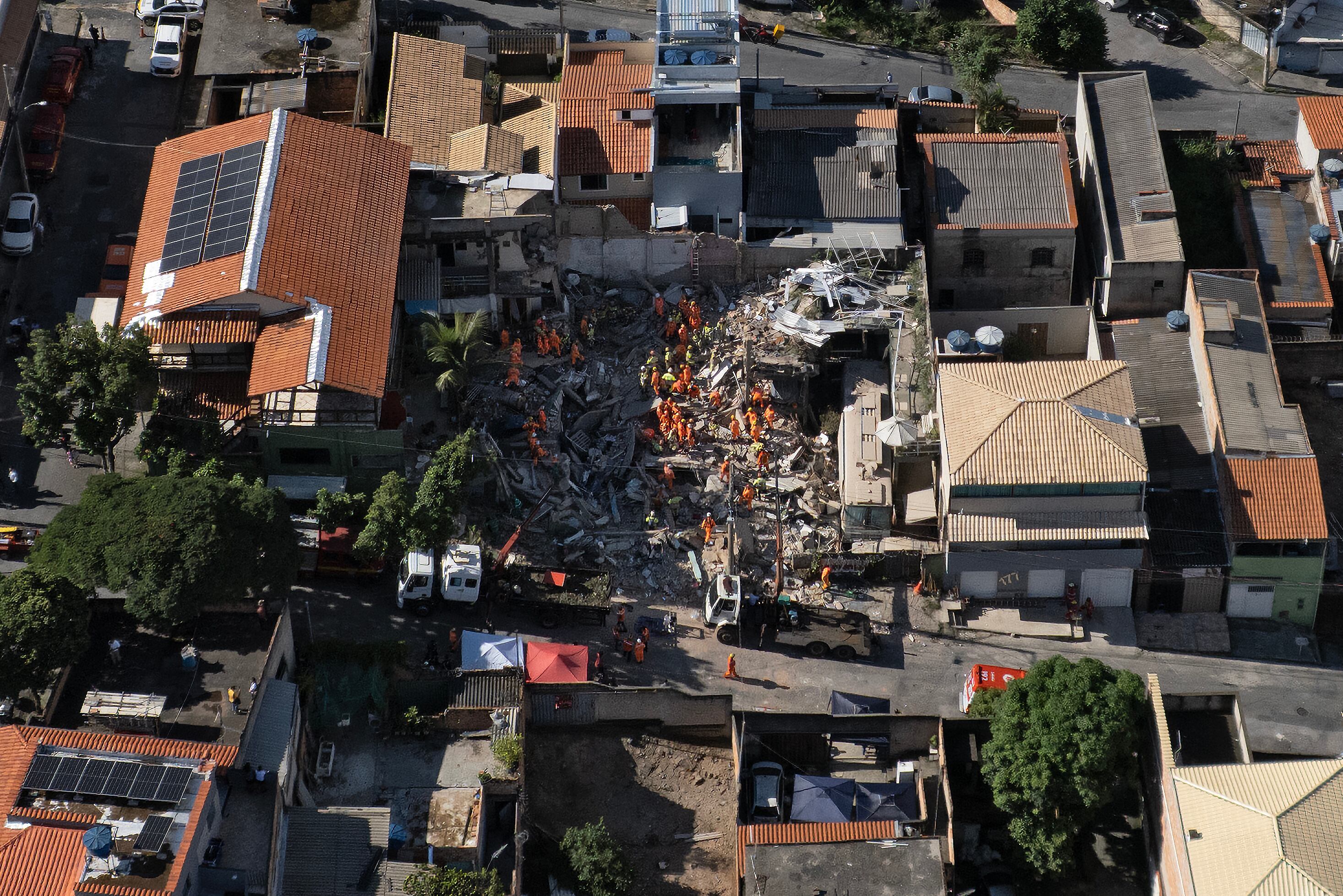 TOPSHOT - Aerial view of Minas Gerais' firefighters working at a collapsed nursing home in Belo Horizonte, Minas Gerais State, Brazil on March 5, 2026. The collapse of a nursing home in the city of Belo Horizonte, in south-eastern Brazil, left at least four people dead while firefighters continue to search the rubble for eight missing persons, according to the latest reports. (Photo by Douglas MAGNO / AFP via Getty Images)